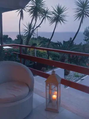 a lantern sitting on a balcony with a view of the ocean at Sea apartment & pool 2 in Palermo