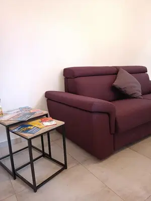 a living room with a couch and a table at Clio's House - Mondello in Mondello