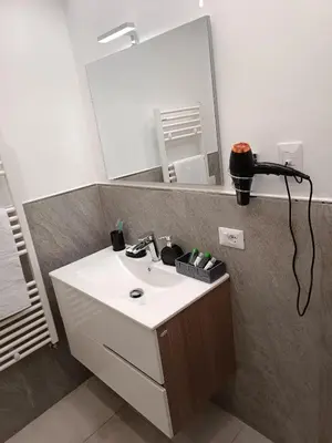 a bathroom with a sink and a mirror at Clio's House - Mondello in Mondello