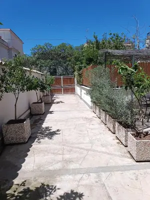 a walkway with trees and plants on a fence at Clio's House - Mondello in Mondello