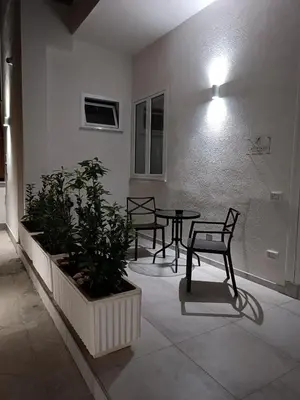 a room with a table and two chairs and a plant at Clio's House - Mondello in Mondello