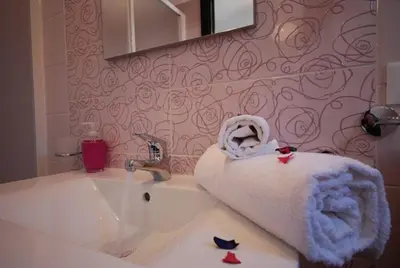a bathroom with a sink with a towel on it at La Chiocciola 2 Bed&Breakfast in Castelluzzo