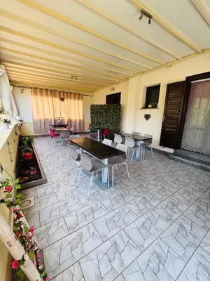 a patio with tables and chairs in a building at La Chiocciola 2 Bed&Breakfast in Castelluzzo