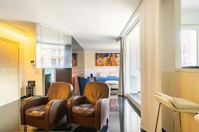a living room with two chairs and a living room at Luxury suite 2 min dal Politeama - Free Parking in Palermo