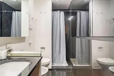 a bathroom with a shower and a toilet and a sink at Luxury suite 2 min dal Politeama - Free Parking in Palermo