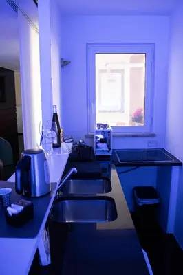a blue kitchen with two sinks and a window at Luxury suite 2 min dal Politeama - Free Parking in Palermo