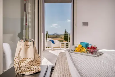 a table with a purse and a tray of fruit at Villa Sikelia in Alcamo