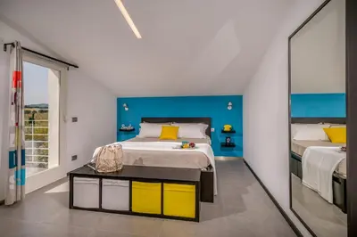 a bedroom with a large bed and a mirror at Villa Sikelia in Alcamo