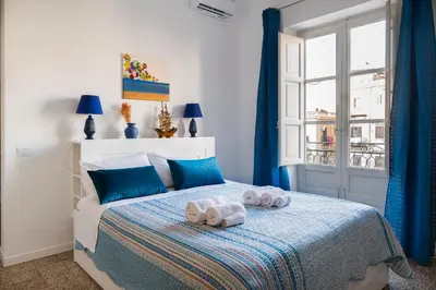 a bedroom with a bed with two towels on it at Da Olga in Palermo