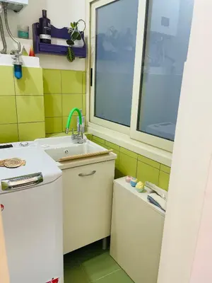 a small kitchen with a sink and a window at Da Olga in Palermo
