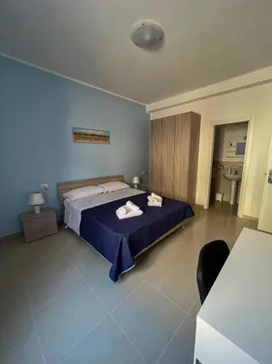 a bedroom with a bed with two towels on it at B&B Marco Polo in Terrasini