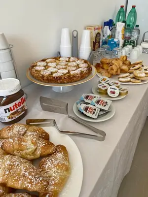 a table topped with plates of pastries and pies at B&B Marco Polo in Terrasini