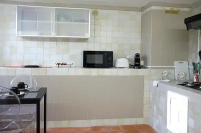 a kitchen with a sink and a microwave at Sea apartment 1 in Palermo