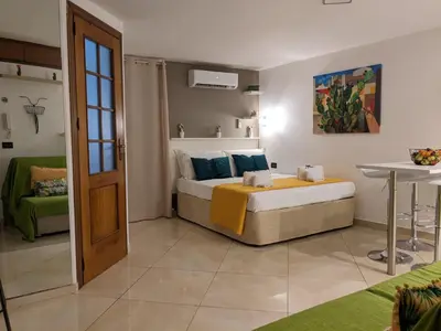 a bedroom with a bed and a table in it at Iverlid Ballarò in Palermo