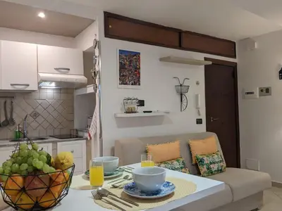 a kitchen with a table with a bowl of fruit on it at Iverlid Ballarò in Palermo