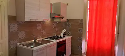 a small kitchen with a sink and a stove at Holiday House Marconi in Castellammare del Golfo