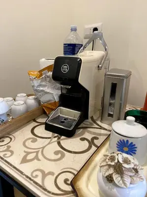 a kitchen counter with a coffee maker on a counter top at Casa Woow in Carini