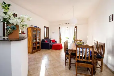 a living room with a table and chairs and a couch at Villa Scirocco Macari in Macari