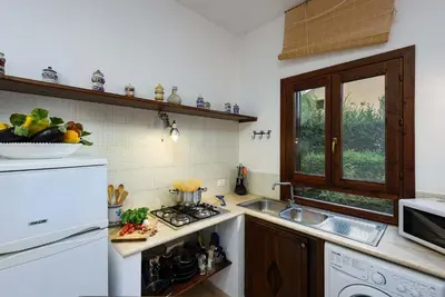 a kitchen with a sink and a stove top oven at Villa Scirocco Macari in Macari