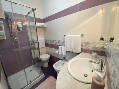 a bathroom with a sink and a shower and a toilet at B&B Le Onde Del Mare in San Vito lo Capo