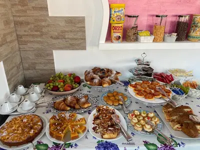 a table topped with lots of different types of food at B&B Le Onde Del Mare in San Vito lo Capo