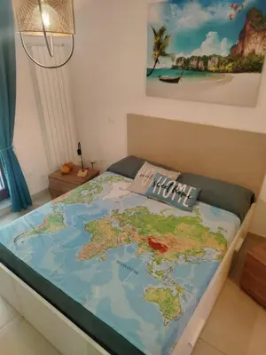 a bed with a map of the world on it at Peri Peri House - Palermo Centro in Palermo