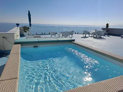 a bath tub in a bathroom with a wall at Blue Life, sea-luxury rooms on the beach between Palermo and Cefalu' in Casteldaccia