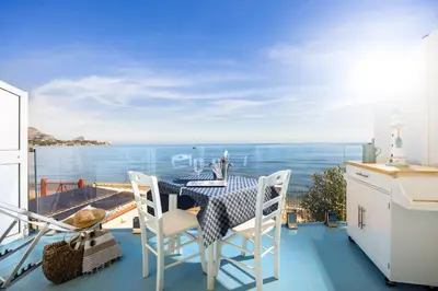 a balcony with a table and a view of the ocean at Blue Life, sea-luxury rooms on the beach between Palermo and Cefalu' in Casteldaccia