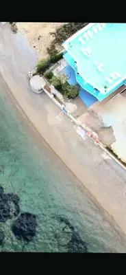 an overhead view of a beach with a building and the water at Blue Life, sea-luxury rooms on the beach between Palermo and Cefalu' in Casteldaccia