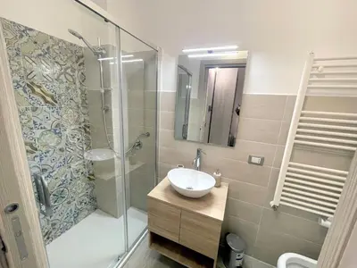 a bathroom with a white sink and a toilet at I MORI - Holiday Rooms in Lascari