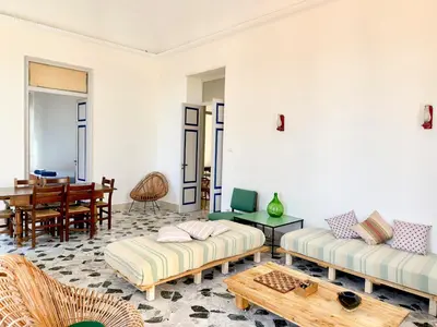 a living room with two couches and a table at Casa Stella Splendida Villa sul Mare in Palermo