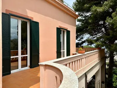 a balcony of a house with green shutters at Casa Stella Splendida Villa sul Mare in Palermo