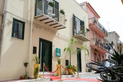 a building with plants on the side of a street at Borgo La Chiusa in Cinisi