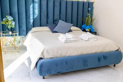 a blue bed with towels on it in a room at Borgo La Chiusa in Cinisi