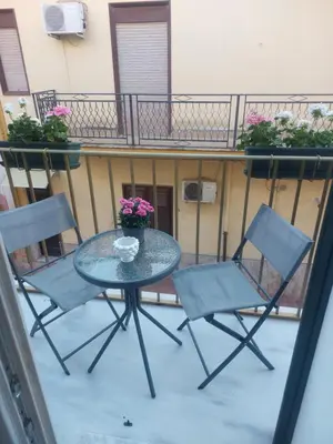 a table and two chairs on a balcony at Borgo La Chiusa in Cinisi