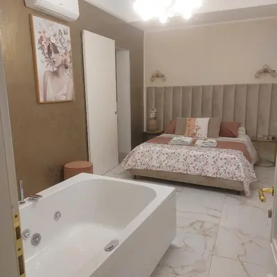 a bathroom with a bath tub and a bed at Borgo La Chiusa in Cinisi