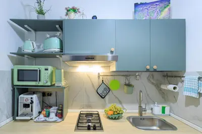 a small kitchen with a sink and a microwave at Vintage Rooms in Palermo