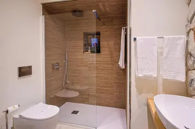 a bathroom with a shower with a toilet and a sink at Vintage Rooms in Palermo