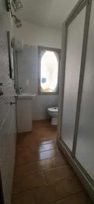 a bathroom with a toilet and a window at La casa di Minù in Palermo