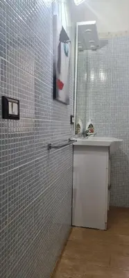a bathroom with a shower with a sink and a mirror at La casa di Minù in Palermo