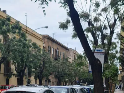 a row of cars parked in a parking lot at La casa di Minù in Palermo