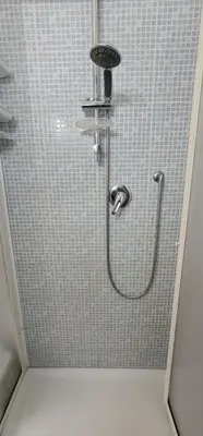a shower in a bathroom with a tiled wall at La casa di Minù in Palermo