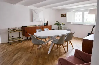 a dining room with a white table and chairs at Palazzo Moncada appartamento 2 in Palermo
