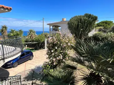 a blue car parked in front of a house at Villa La Terrazza Sul Mare di Trabia - Location fra Palermo e Cefalù in Trabia