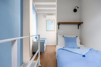 a small room with a bed and a staircase at Sette Fate Suites & Spa in Palermo