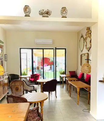 a restaurant with tables and chairs and a couch at Sette Fate Suites & Spa in Palermo
