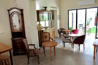 a room with tables and chairs and a room with windows at Sette Fate Suites & Spa in Palermo