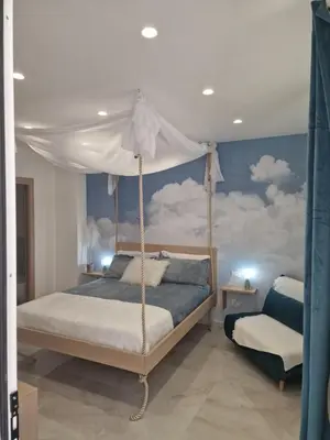 a bedroom with a bed with a canopy at The waves in Terrasini