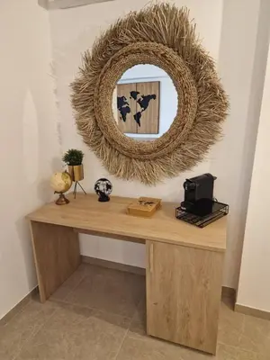 a mirror sitting on top of a wooden table at The waves in Terrasini
