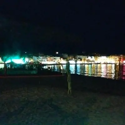 a view of a harbor at night with lights at Mondello Ashur Margot House in Palermo